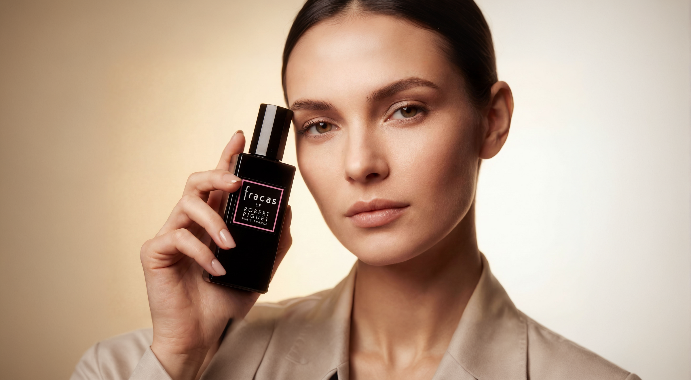 Woman holding Fracas Eau de Parfum