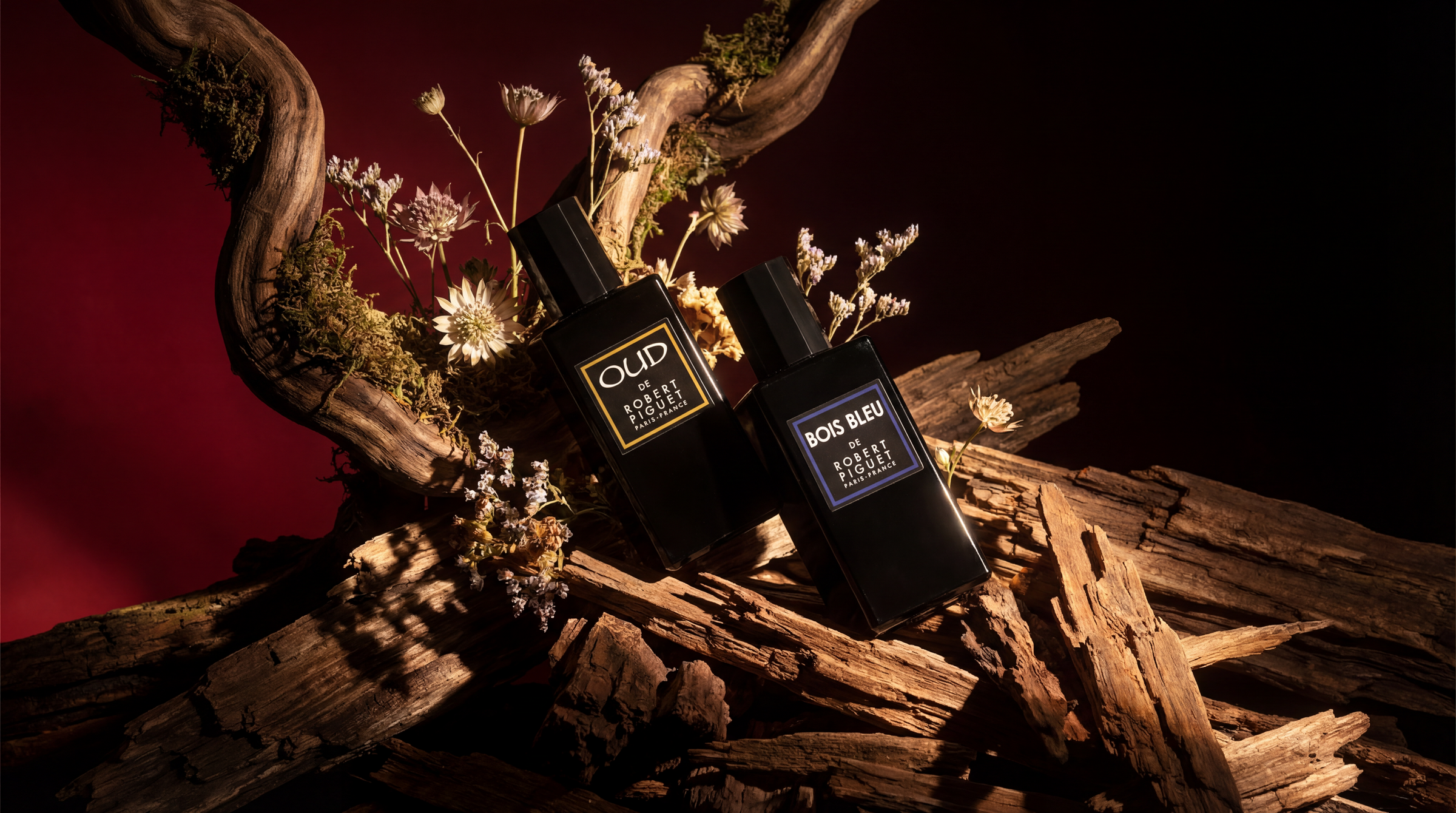 OUD and Bois Bleu bottles on a wooden background